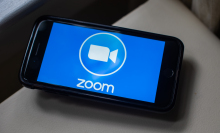 zoom logo on phone on table