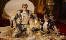 Two men on the floor covered in wedding cake; a still from Red, White & Royal Blue