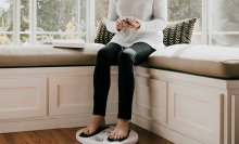woman sitting with feet on the therapy pad