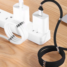 The Aduro Fidget Magnetic Self-Winding Lightning Cable shown in both black and white, connected to an adapter