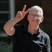 Tim Cook smiling and flashing the peace sign