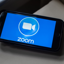 zoom logo on phone on table