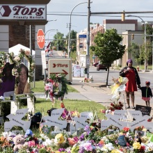 A memorial of photos for victims of the Buffalo, New York, mass shooting at Tops grocery store.