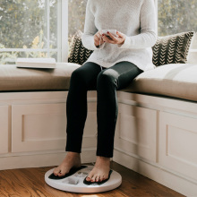 woman sitting with feet on the therapy pad