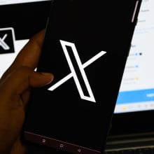 x app on screen and computer