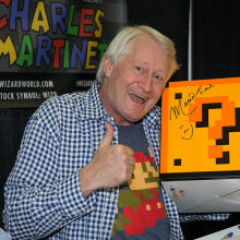 Charles Martinet posing with a Mario question block 