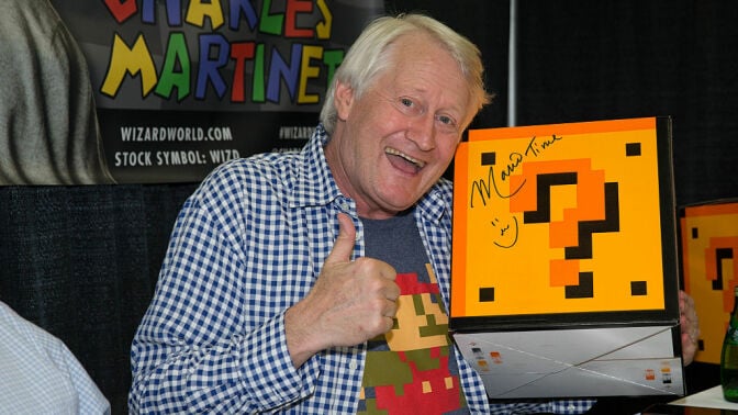 Charles Martinet posing with a Mario question block 