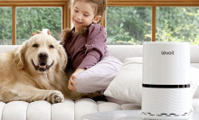 girl and dog sitting beside air filter