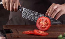 person using Konig Kitchen knife to slice tomato