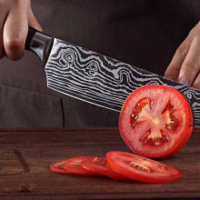 person using Konig Kitchen knife to slice tomato
